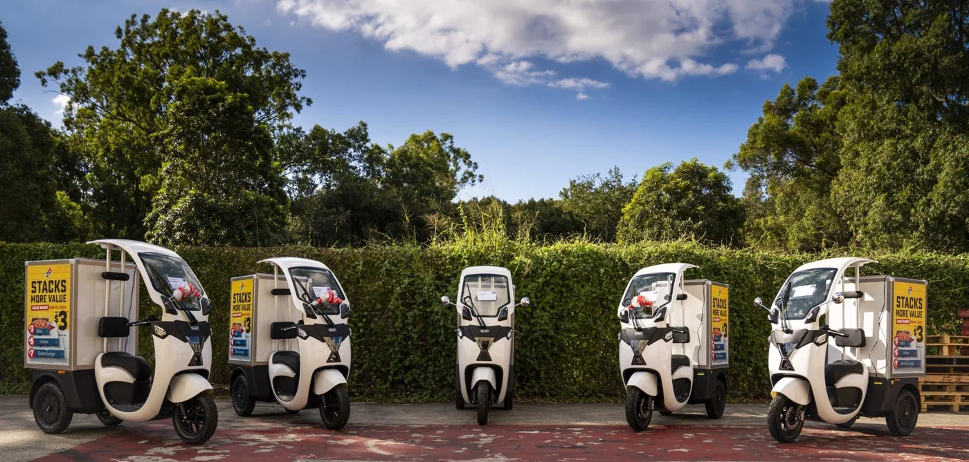 Line-up of five RAP SEV electric three-wheelers with cargo boxes